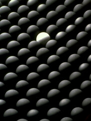 One white ball surrounded by many black balls.