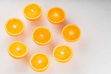 Fresh ripe oranges on a white background. Halves of juicy oranges for vegan