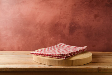 Wooden log with tablecloth on table over rustic wall  background. Kitchen interior mock up for...