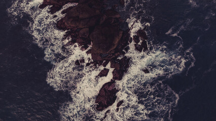 Ocean waves churning on the cliff.