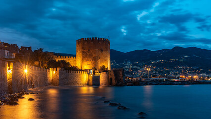 Alanya, Turkey, April 9th 2021 .Stunning panorama of Alanya Harbour and the Red Tower at night with...