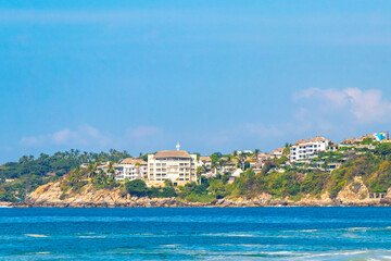 Fototapeta na wymiar Beach sand blue water huge surfer waves Puerto Escondido Mexico.