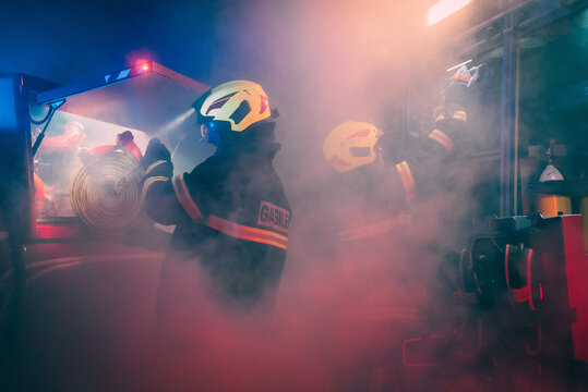Firefighters taking the equipment out of the firetrucks.
