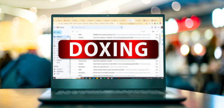 Laptop displaying the sign of doxing on the internet