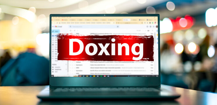 Laptop displaying the sign of doxing on the internet