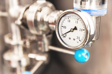 Pressure gauge on the pipe - Powered by Adobe
