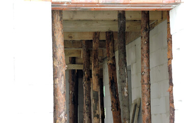Wooden building props inside a house under construction