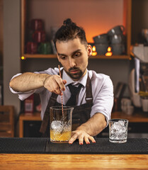 Barman stirring fresh alcoholic cocktail