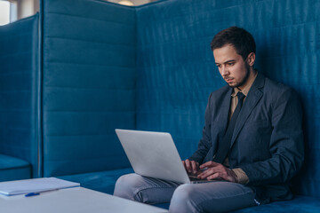 Businessman works in cubicle at corporate business