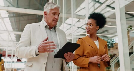 Tablet, advice and business people walking for corporate strategy, digital budget report or finance review. Communication, talking and ideas of senior manager with black woman in accounting workplace - Powered by Adobe