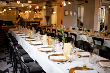 Table in restaurant wedding dinner celebration flowers chairs decorations simple preparations event