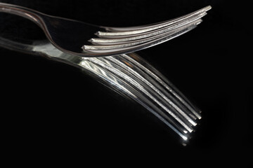 Close up of kitchen forks on dark background with selective focus