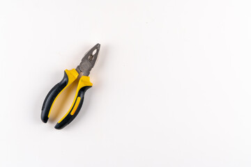 Top view of universal pliers on isolated white background with text area.