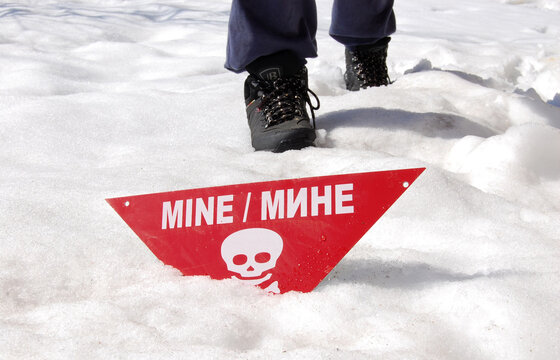person on the snow mines sign