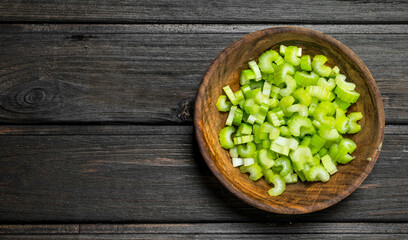 Fototapeta na wymiar Pieces of celery in a wooden bowl.
