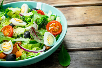 Vegetable salad. Tomato, cucumber and quail egg salad with olive oil and Basil.