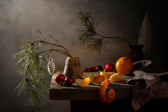 Still life of a pine branch in a vase and Christmas decorations