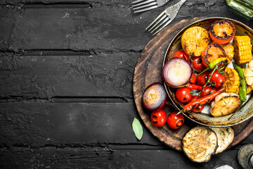Grilled vegetables in a pan with herbs and spices.