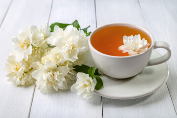 Jasmine tea in a cup on a wooden background