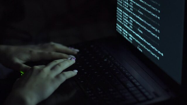 Female hacker coding working hackathon at laptop