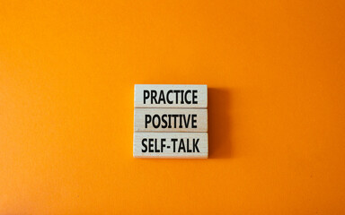 Practice positive self-talk symbol. Concept words Practice positive self-talk on wooden blocks. Beautiful orange background. Business and Practice positive self-talk concept. Copy space