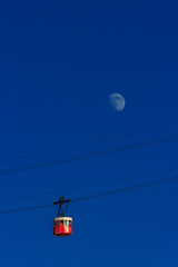 Barcelona cable car with the moon in the background