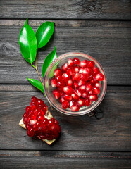 Pomegranate seeds in glass bowl.