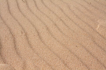 Fototapeta na wymiar Background with waves of sand macro photography