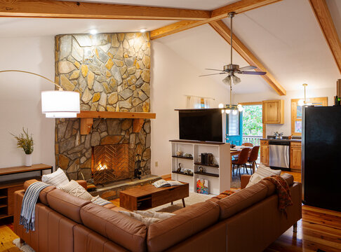 A warm cabin in the woods of North Carolina with a fire and tv.