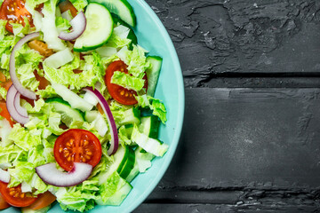 Fresh vegetable salad of tomatoes, cucumbers and red onions.