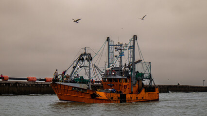 Fishing boat on the sea with seagulls
