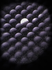 Many black balls surrounding a single white ball