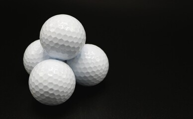 golf ball stack on black background