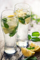 misted glass with cold water, lemon and mint