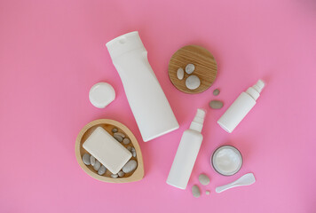 Cosmetic products for personal care on a pink background. Cream, spray, serum, shower gel, soap, dental floss.