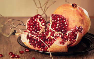 still life with cut pomegranate on a wooden table
