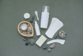 Cosmetic products for personal care on a gray background. Cream, spray, serum, shower gel, soap,...