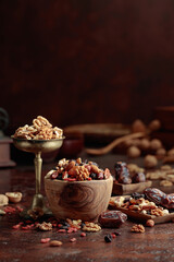 Dried fruits and nuts in a wooden bowl.