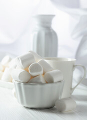 Fototapeta na wymiar White marshmallows on a wooden table.