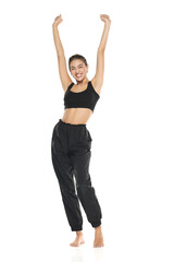 a young barefeet happy woman in black sweatpants and a tank top on a white background