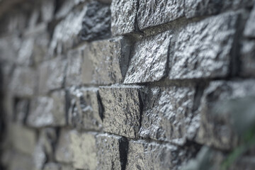 A wall of dark decorative coal-like stones, close-up.