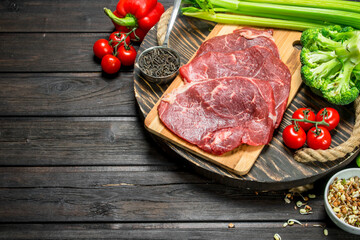 Healthy food. Raw beef meat with organic food assortment .
