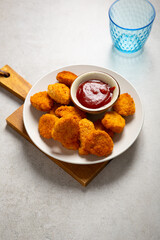Chicken crunchy nuggest on plate and sauce