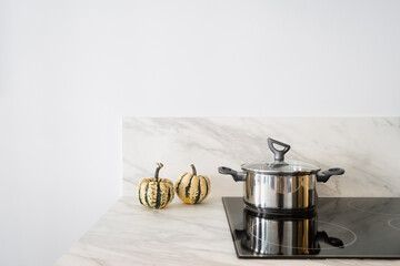 cooking pot with lid on electrical hob at kitchen