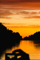 Picture in picture of an orange colorful sunset in Danube Delta