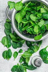 Fresh spinach in a saucepan and salt.