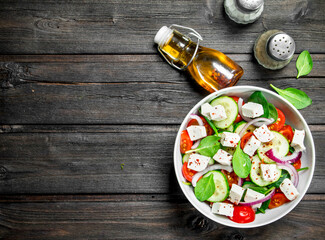 Fototapeta na wymiar Vegetable salad. Salad with vegetables, cheese and olive oil.