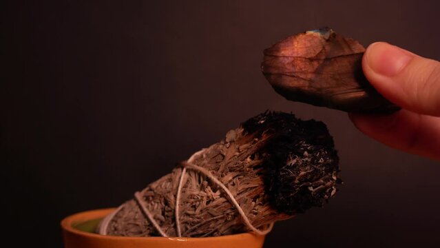 Cleansing orange labradorite crystal with white sage smoke
