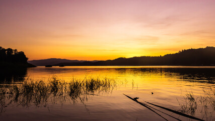landscape sunset with Reservoir and raft house Thailand