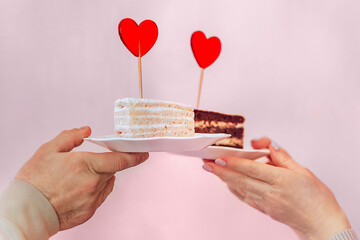 a man and a woman are holding plates of cake in their hands, with a red heart-shaped lollipop...